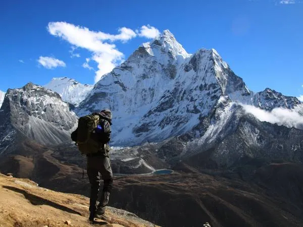 Man standing in front of Mount Everest