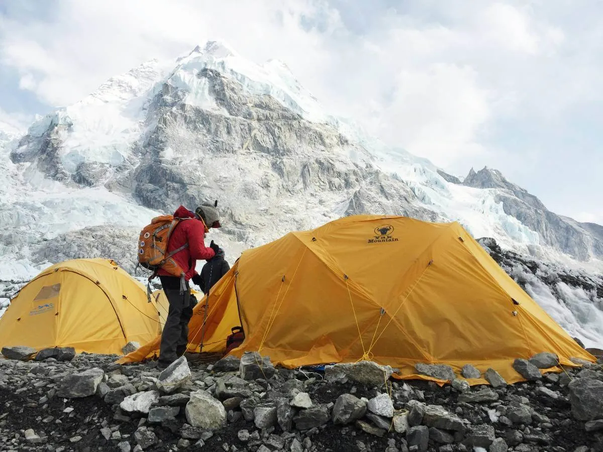 Local sherpa arranging tent at Everest base camp
