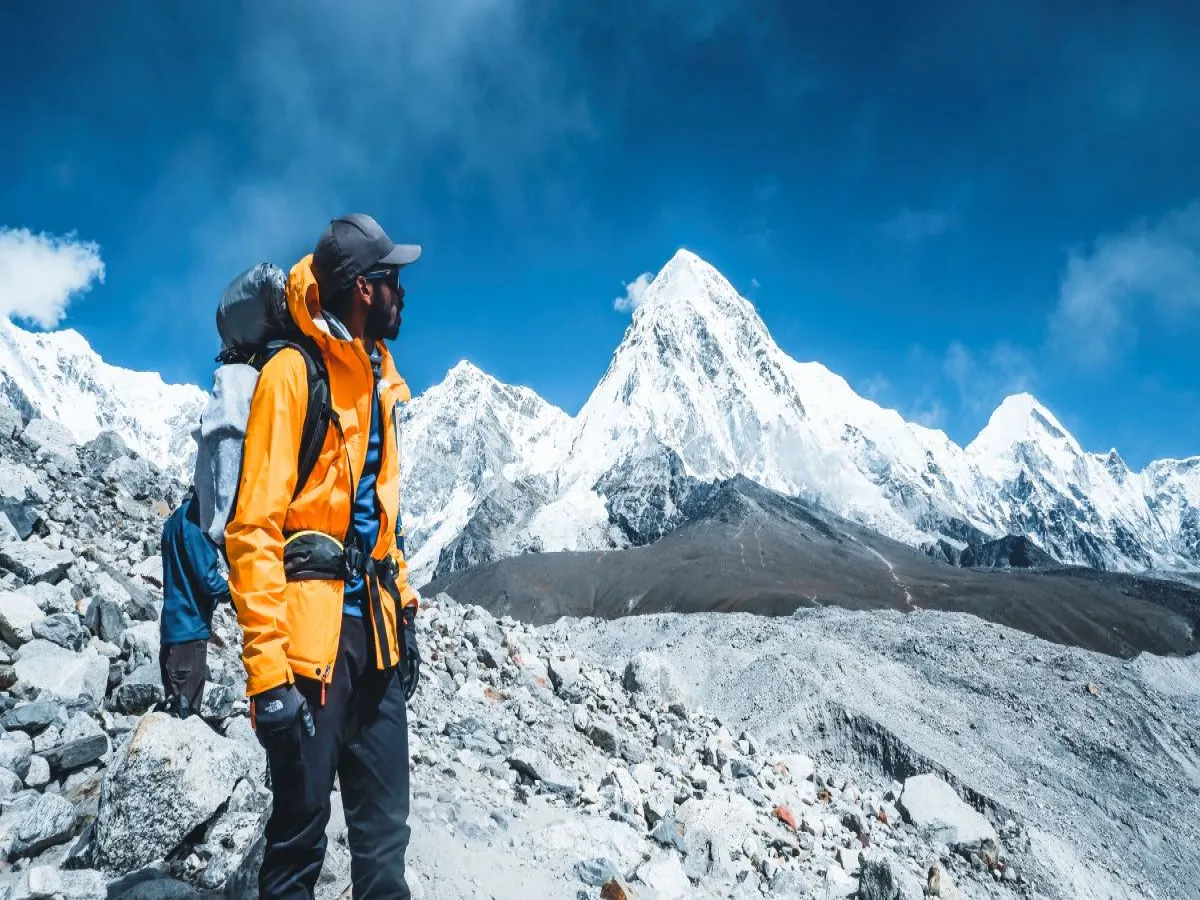 Man standing in front of Khumbu glacier during premium everest trekking