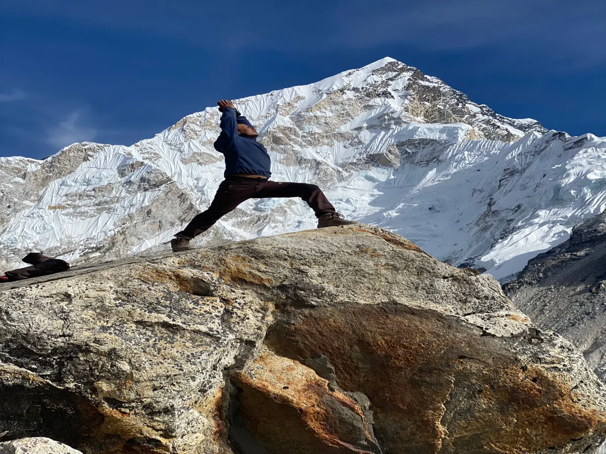 People doing  Prayanam in front of the mountains