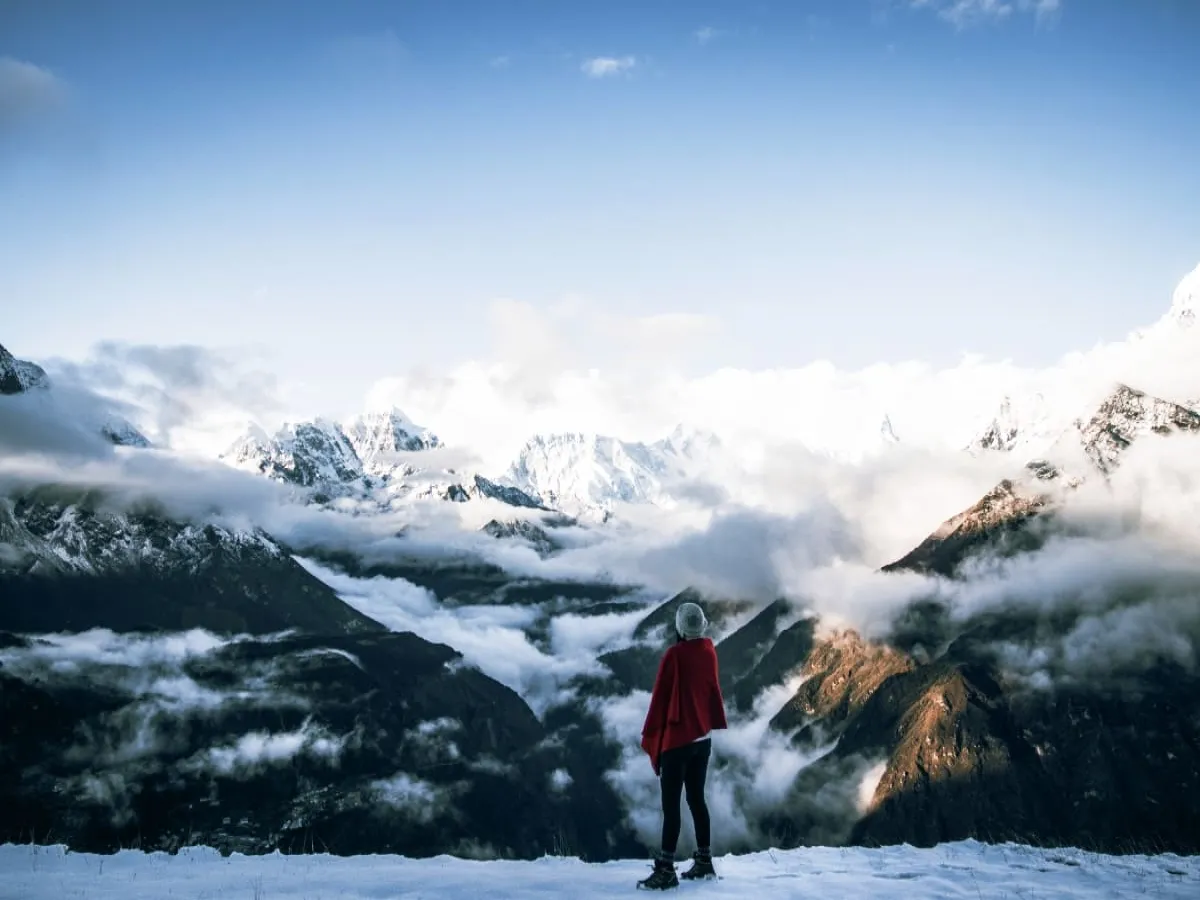 Trekker viewing mountains standing at Kyanjin Ri