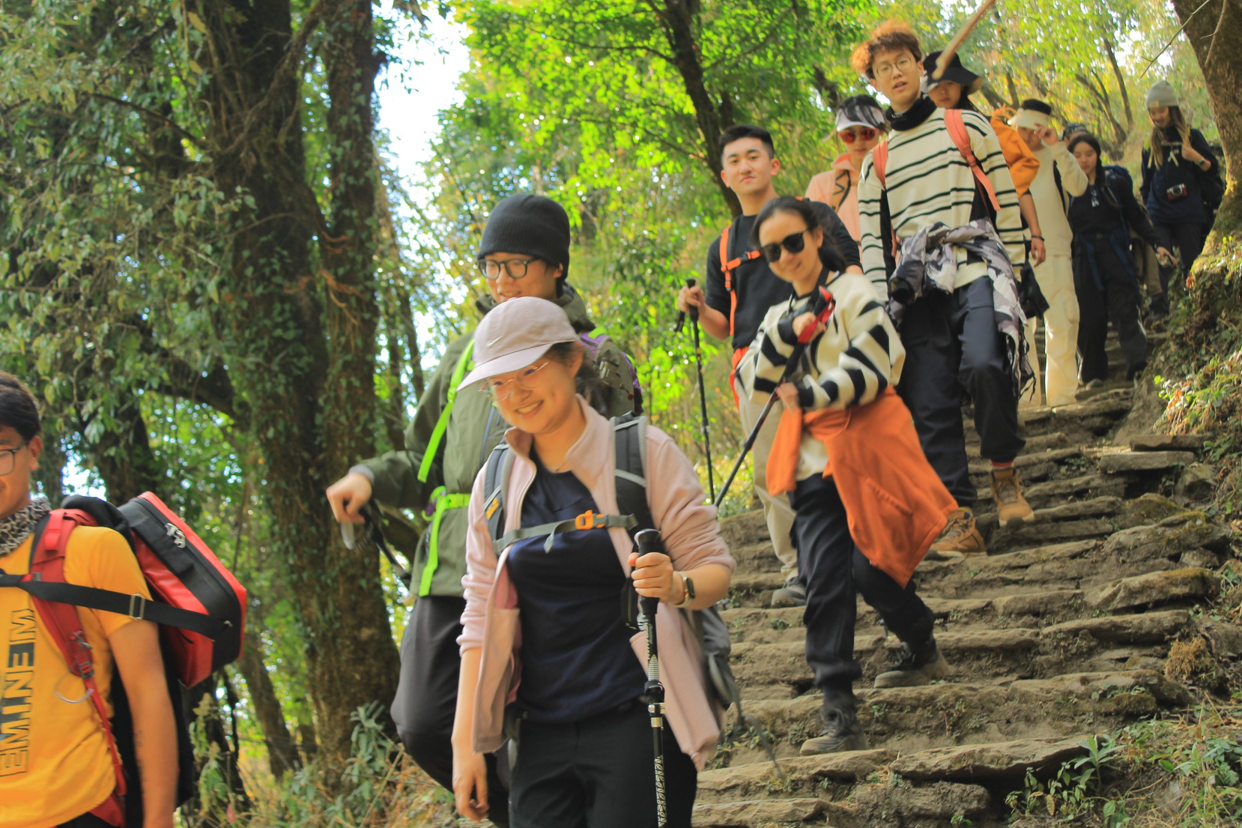 Trekkers walking along a trail near Bamboo on the Annapurna Base Camp trek route.
