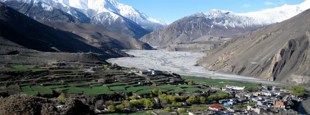 Aerial view of Dolpo to Mustang traverse with cliffs, valleys, and snow-capped peaks.