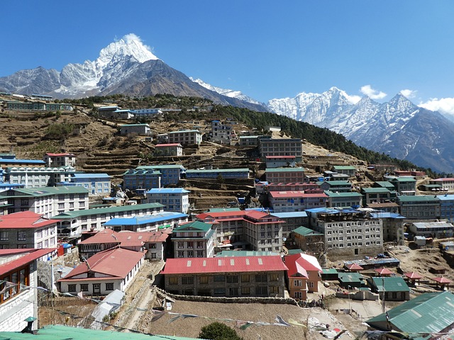 Aerial view of Namche Bazaar, a bustling mountain town surrounded by majestic peaks in the Everest region.