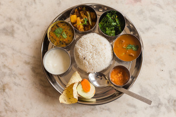 Traditional Nepali Khana set featuring dal, bhat, tarkari, and achar - a complete Nepalese meal.