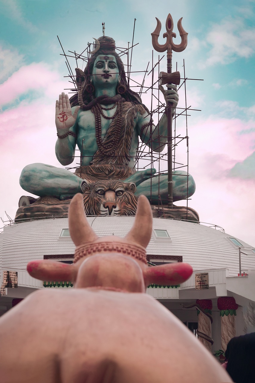 An image of Pumdikot Temple in Pokhara, Nepal, featuring a grand Lord Shiva statue, surrounded by verdant hills and stunning views of the Annapurna mountain range.