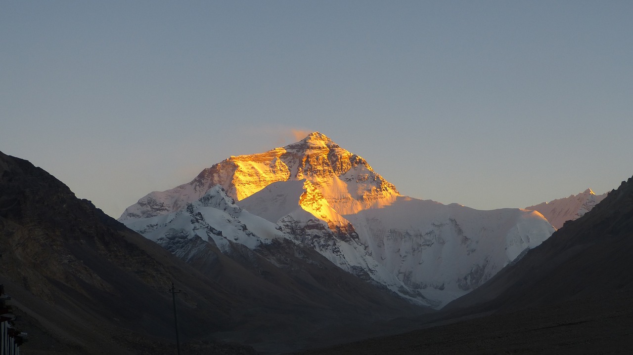 Sunrise over Mount Everest, with golden light illuminating the world's highest peak.