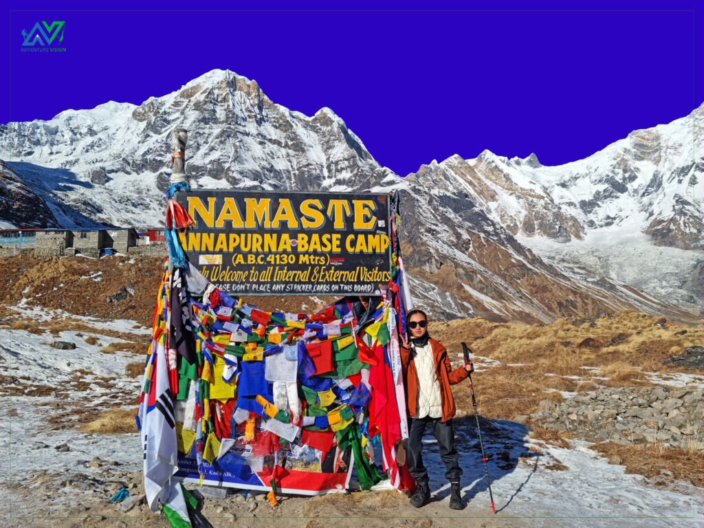 Standing tall at Annapurna Base Camp trekker in front of the ABC welcome board.