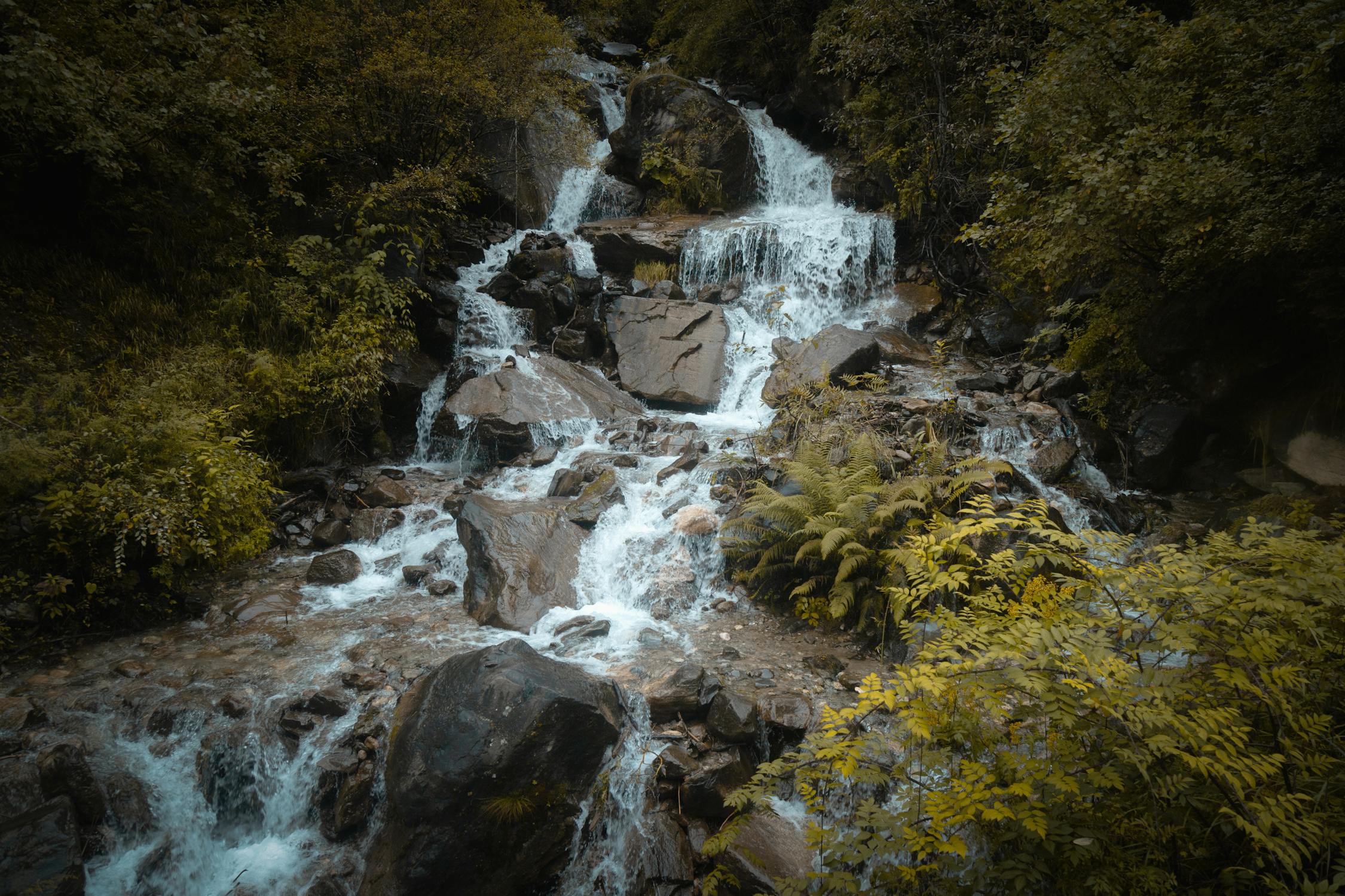 Beautiful glacial river in Macha Khola, Manaslu region, with turquoise waters flowing through rocky Himalayan terrain.
