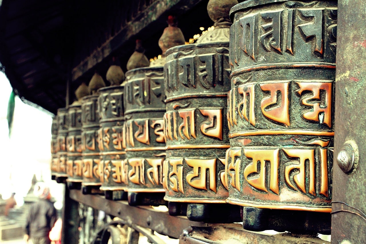 The Dharmachakra, often found on the side of stupas, symbolizing the teachings of Buddha and the path to enlightenment.