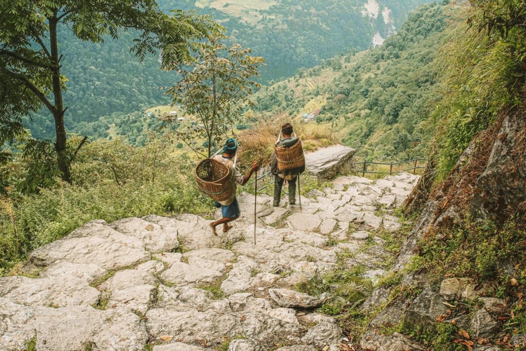 Locals descending the rugged stone staircase on the Manaslu Circuit