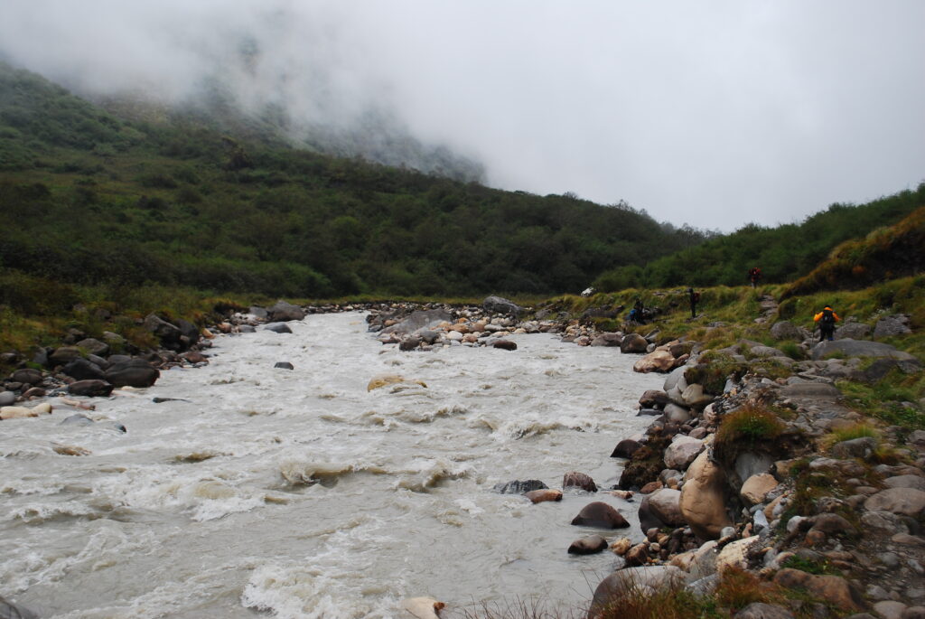 The Kali Gandaki River winding through a deep valley with steep mountain cliffs on either side.