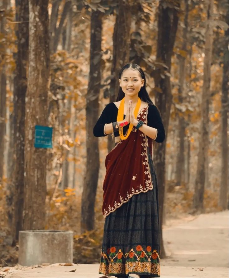 A graceful Gurung girl greets with a traditional Namaste, reflecting the warmth and hospitality of the Himalayan culture.