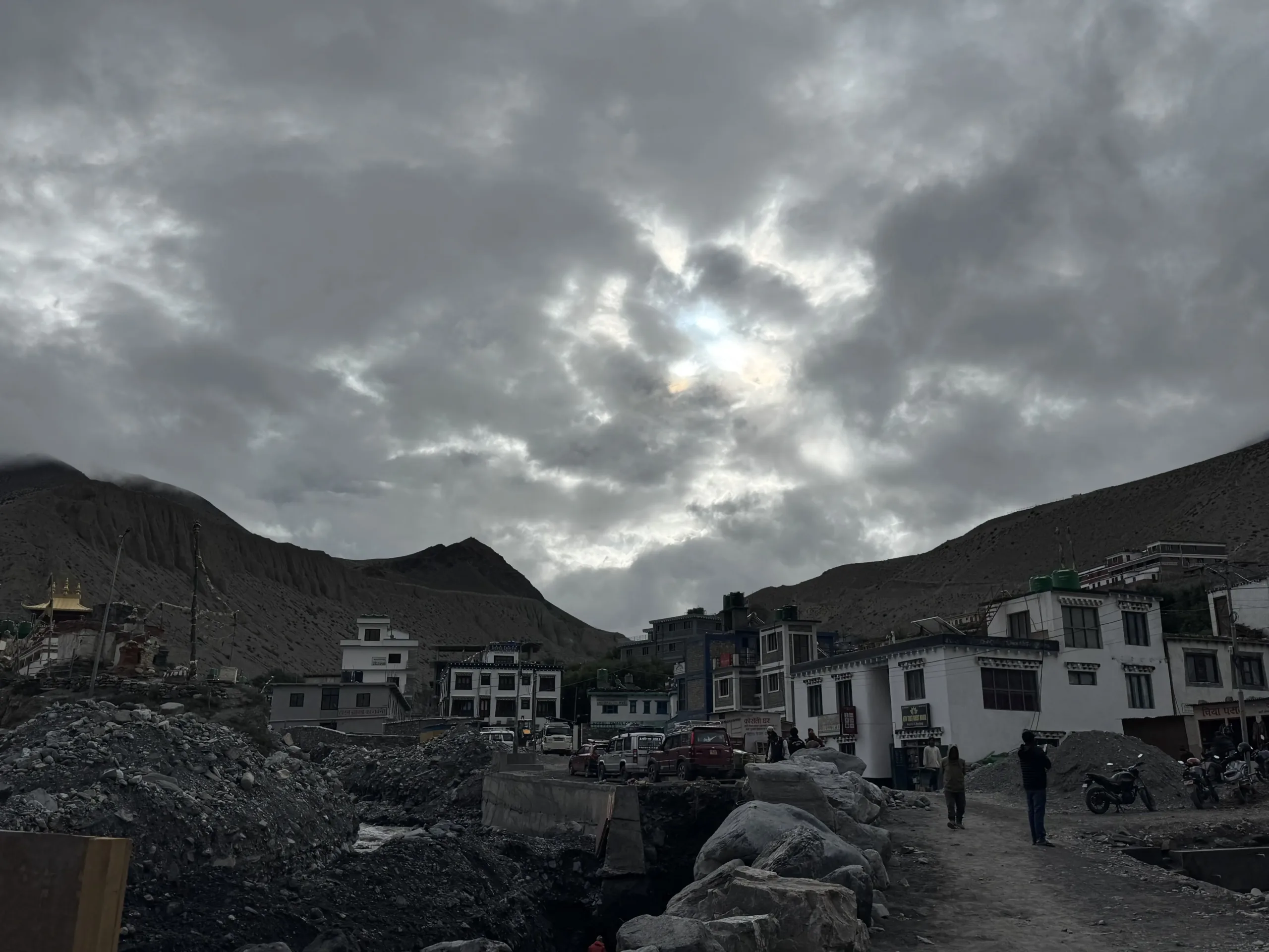 A picturesque Himalayan village with stone houses and colorful prayer flags on the Annapurna Circuit trek.