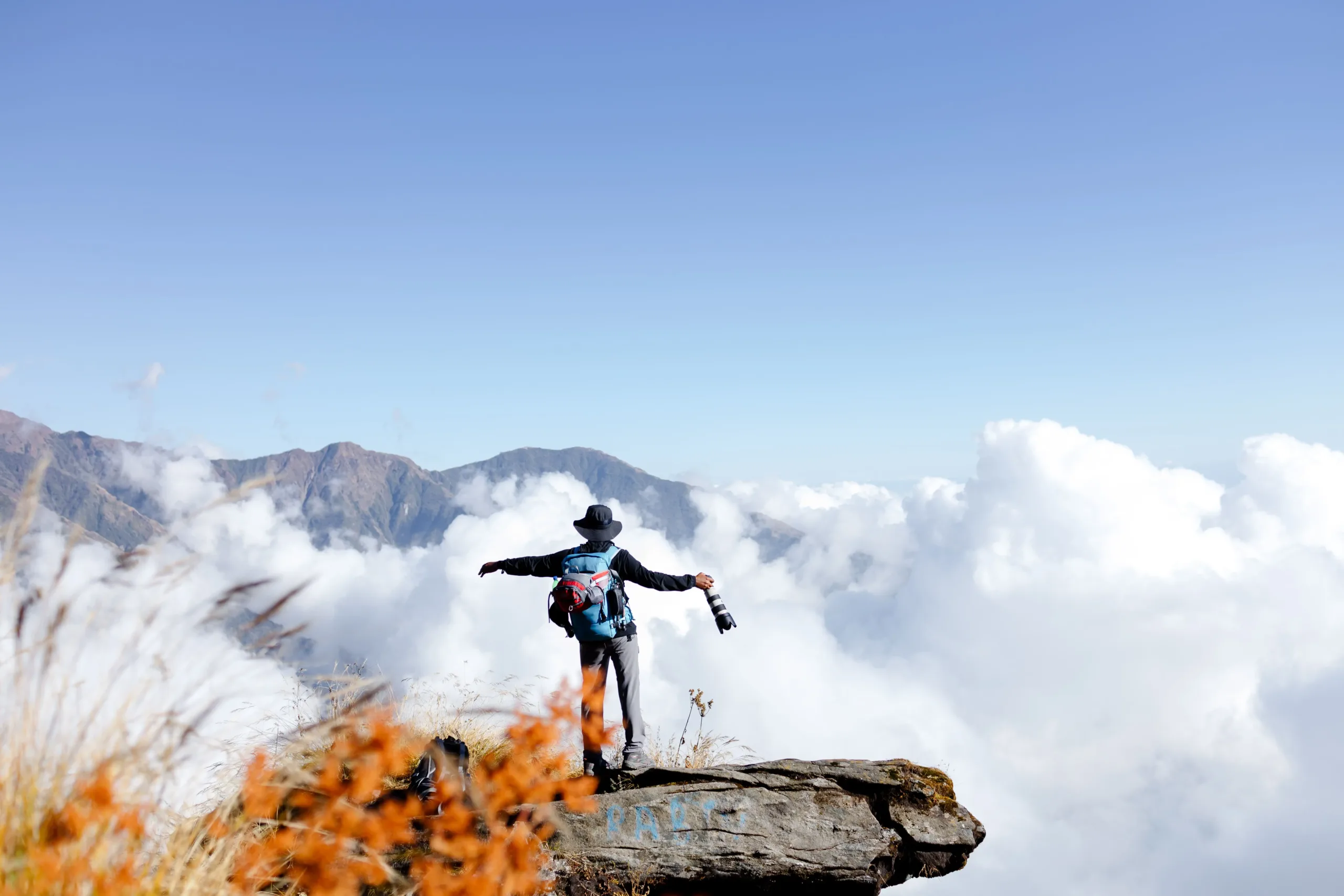 Trekker posing for a photo in clear mountain weather during a Nepal Himalaya trek.
