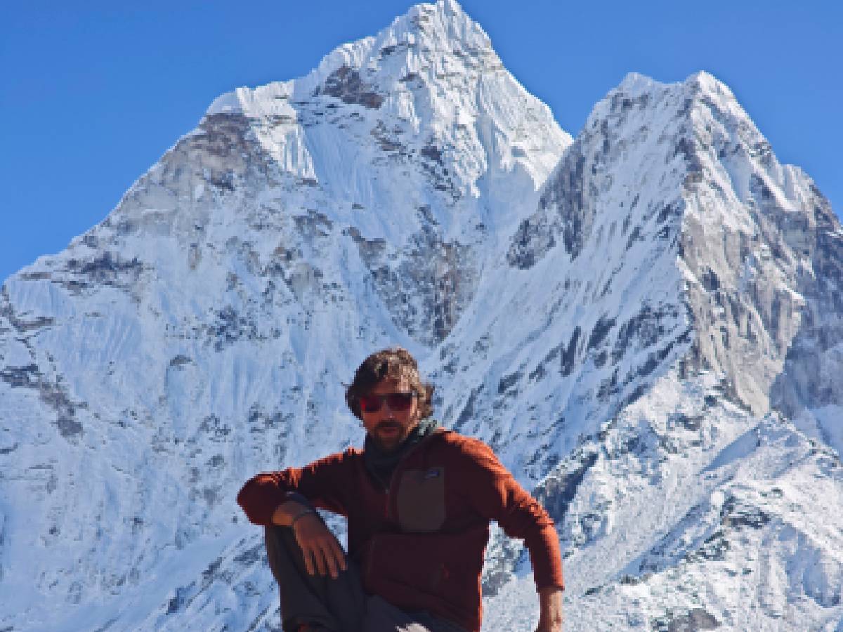 Trekker clicking pictures in front of Manaslu mountains