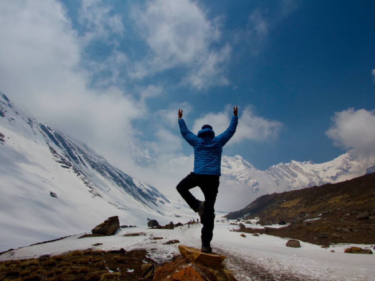 Trekker doing yoga on mountains