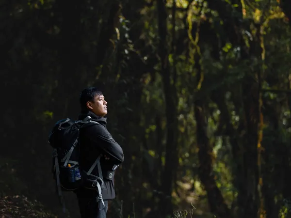 A Trekker Standing And Posing For Picture At Beni