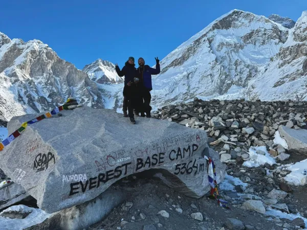 Trekker Standing On Everest Base Camp Stone