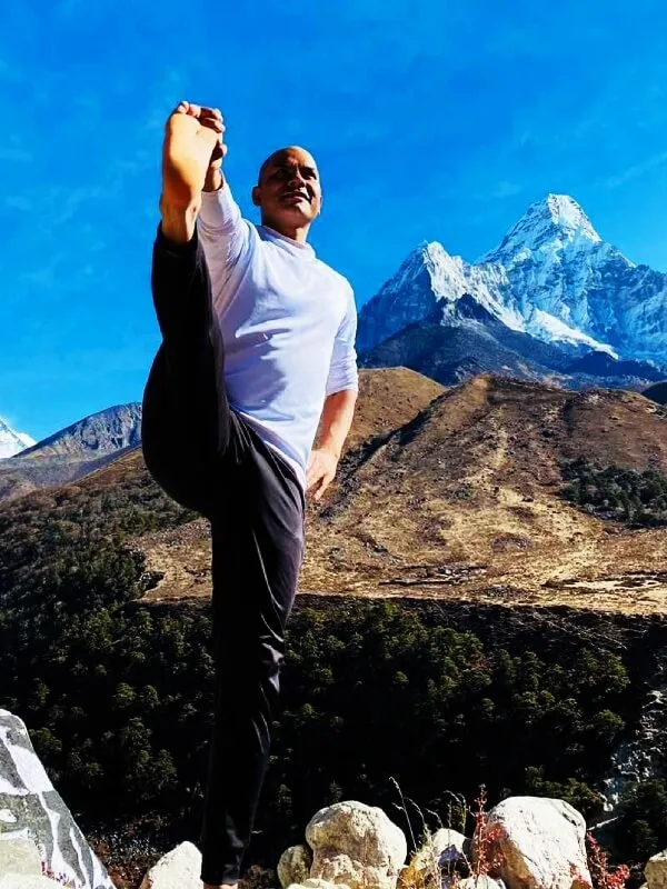 Instructor doing yoga on Mardi mountains