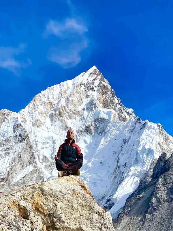 Yoga guru doing yoga in front of the mountains range